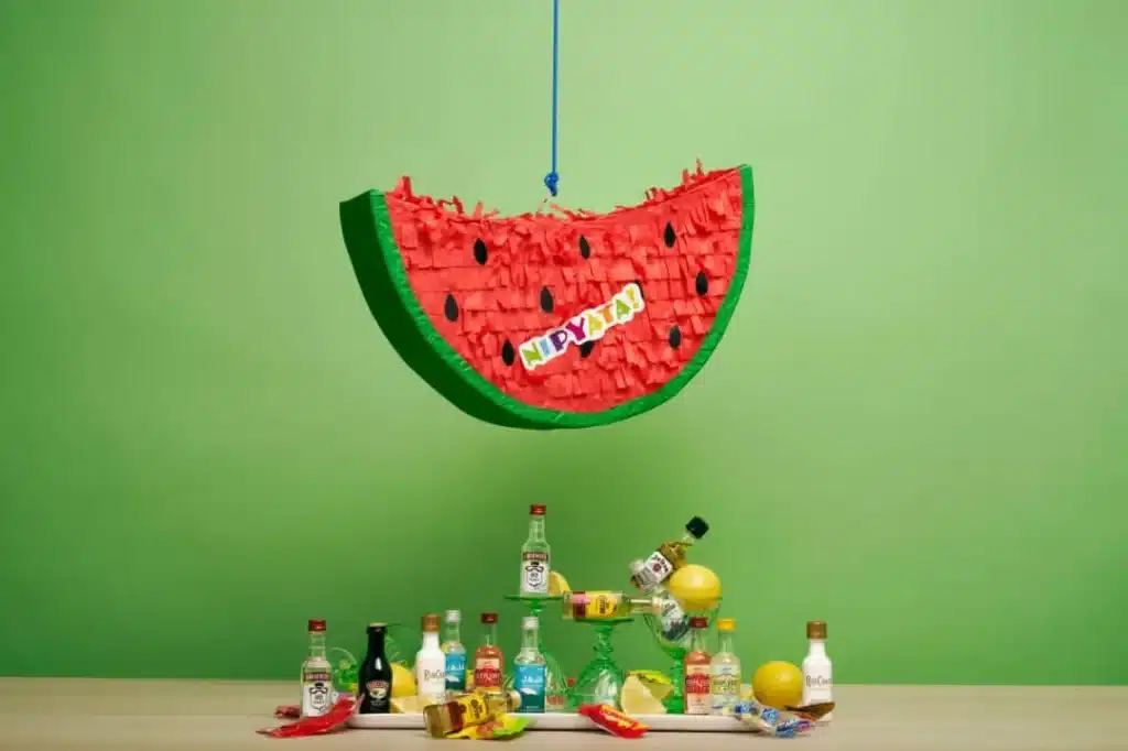 green and pink heart-shaped wall decor. (A watermelon piñata filled with mini plastic bottles of the best liquor and candies. The ultimate boozy gift.)