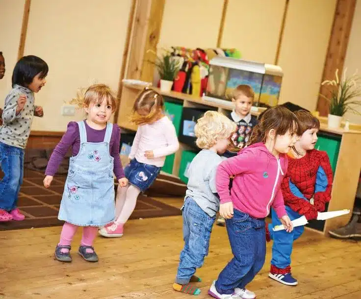 Kids in their early childhood age having fun in their classroom. A reflection of the kind of fun they would have when there is integration of music bingo in the classroom