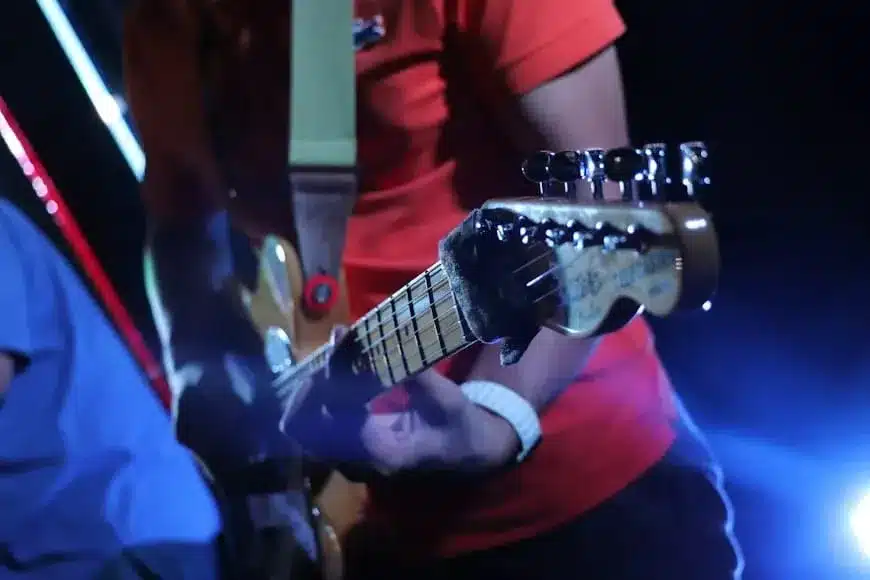a person playing a guitar on a stage
