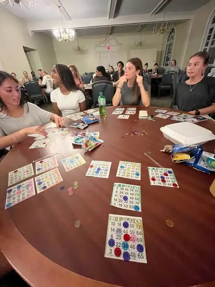 Group of friends at a music bingo event, highlighting fun in music bingo business