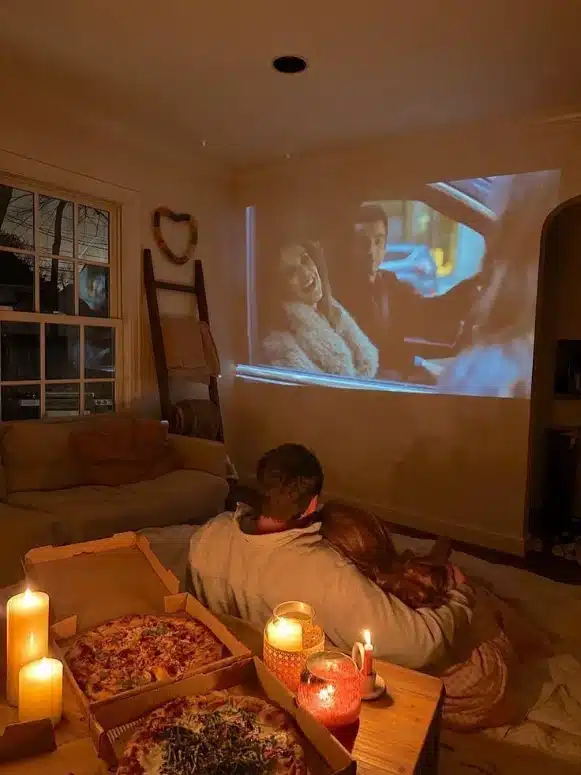 Valentine's Day date ideas
: Cozy couple cuddling on a couch with candles
