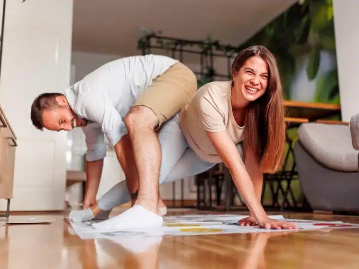 Happy couple playing a game at home
