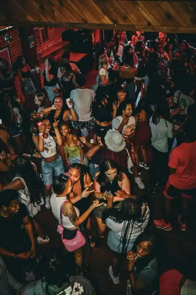 Energetic crowd dancing in a colorful African club